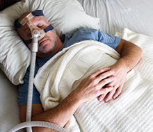 Man with CPAP nasal mask and oral appliance